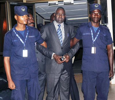 Genocide suspect Bernard Munyagishari (C) after being handed over to the Rwandan security at Kigali International Airport in July last year. Munyagishari was transferred to Rwanda ....