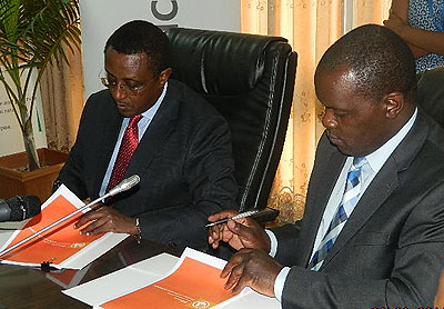  Education minister, Vincent Biruta and Microsoft country manager for Eastern and Southern Africa, Eric Odipo, during the signing of the deal on Thursday. John Mbanda.