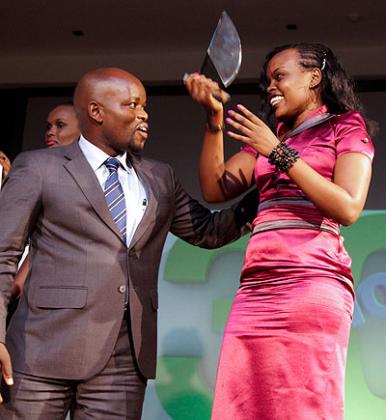 Minister of Youth and ICT, Jean Philbert Nsengimana congratulates  Marie-Louise Uwizeyimana on winning the Journalist of the Year 2013 award. Courtesy.