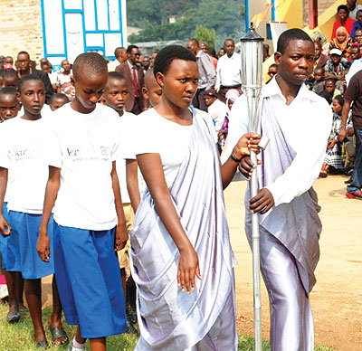 A group of young people accompany the Kwibuka Flame in one of its past stops in its ongoing national lap of honour. The Flame is a symbol of a new, buoyant Rwanda. File.