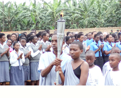 The Kwibuka Flame is carried to Mukarange Sector yesterday. Jean Pierre Bucyensenge.