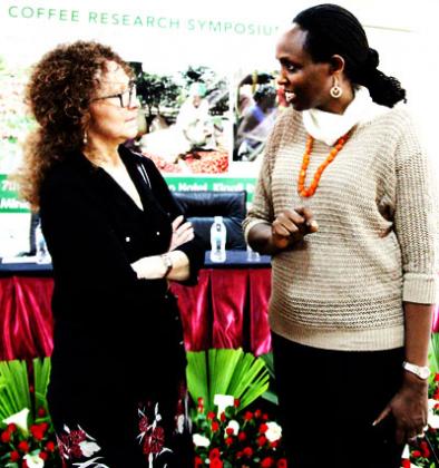 Dr Kalibata (R) chats with the Executive Director of Alliance for Coffee excellence, Susie Spindler, at the coffee research symposium in Kigali yesterday. John Mbanda. 