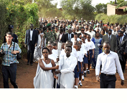 Hundreds of residents joined the journey as the Flame was carried from Mwurire Cell headquarters to a local memorial site on Thursday. JP Bucyensenge.