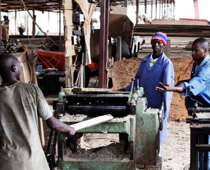 Workers at a workshop in Gakinjiro. Much as the law protects them from exploitation, it is silent on the minimum wage. (Timothy Kisambira)