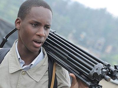 Ishimwe carries his equipment as he prepares to start work. (Moses Opobo)