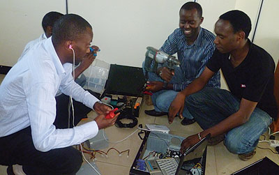 Cyusa (second, left) and his team testing communication speed of a device. Cyusau2019s firm offers WiFi services among others. The New Times / Seraphine Habimana