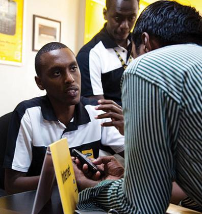 An MTN employee attends to a client. It is important to give customers good service to keep them fulfilled. The New Times / File photo.