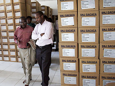 Dr Jean-Damascu00e8ne Gasanabo (R) chats with MP Franu00e7ois Byabarumwanzi during a tour of the Gacaca Archives facility last week. (John Mbanda)