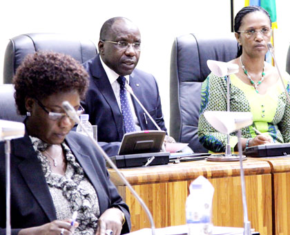 Premier Habumuremyi (C) delivers the economy report in Parliament as State Minister for Local Government Alivera Mukabaramba (L) and Senate Deputy President Jeanne du2019Arc Gakuba f....