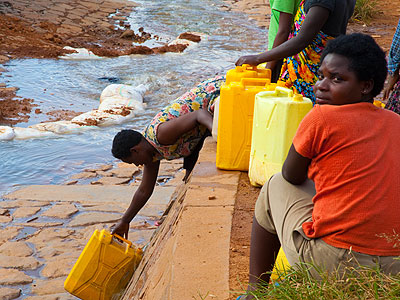 People drawing water in Kimisagara, Kigali. EWSA officials have failed to account for 40 per cent of generated water. (Timothy Kisambira)