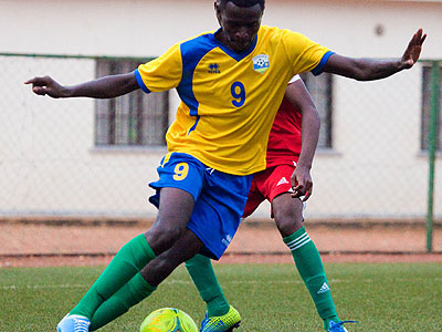 Rwandau2019s U-20 striker Bertrand Iradukunda tries to go round a Burundian defender during Wednesdayu2019s friendly match. (Timothy Kisambira)