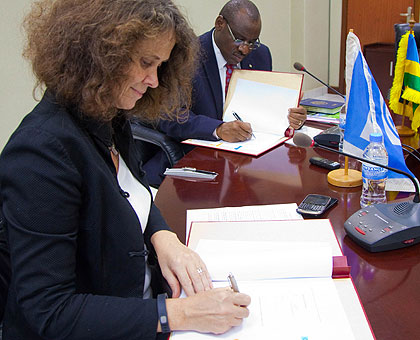 World Banku2019s Turk (L) and Amb. Gatete sign the feeder roads deal in Kigali yesterday. (Timothy Kisambira)