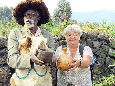 A tourist samples a traditional healeru2019s wares at Nyakinama village. (Moses Opobo)