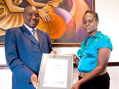 Muia, the General Manager of Serena (L) Hotels in Rwanda poses in a photo with Alicia Akoth of SGs Kenya Limited . (Timothy Kisambira)