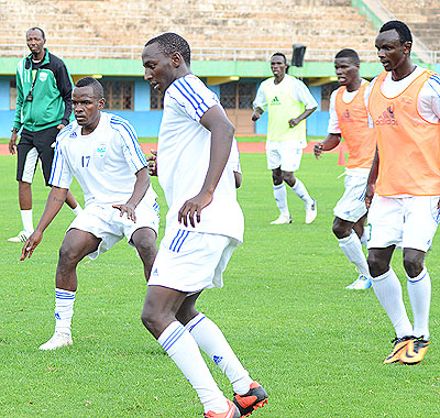 Amavubi Stars coach Eric Nshimiyimana, far left, oversees his players during a training session. File