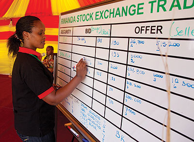 A dealer computes the dayu2019s trade at the local bourse. EAC stock markets are pushing for similar laws to ease movemnet of capital across the region.