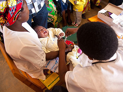 A nurse at Busanza health centre in Kicukiro District administers a vaccine to a child. (File)