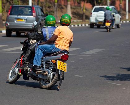 A motorcyclist carries a passenger. Motorcycle taxi operators caught breaking the rules will be penalised. (File)