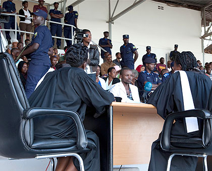 Sylvestre Hora (centre), the convicted murderer of 12-year-old Shalom u2018Bellau2019 Uwase, listens as the bench reads out the verdict at Kigali Regional Stadium yesterday.  He was se....