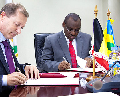 March Pecsteen, the Belgian ambassador to Rwanda (L), and Finance and Economic Planning minister Claver Gatete sign the public health funding deal in Kigali yesterday. T. Kisambira.