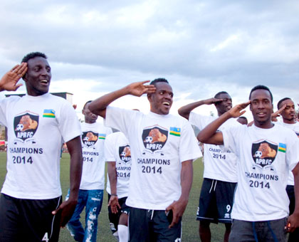 L-R Herve Rugwiro, Charles Tibingana and Nova Bayama and their teammates  celebrate the clubu2019s 14th league title at the Kigali Regional Stadium yesterday. T. Kisambira