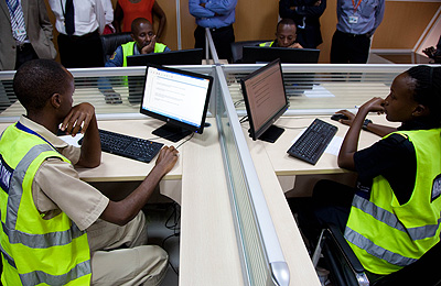 Candidates of the new EAC aviation examination system check for some information in the examination room at Kigali International Airport yesterday. T.Kisambira. 