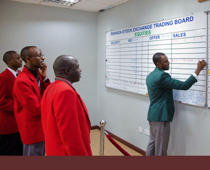 Brokers transact bussiness at the Rwanda Stock Exchange head Offices in Kigali. File.