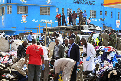 Good Samaritans help out the injured. Twin explosions killed at least 10 people and injured close to 70 others  in a packed Nairobi market yesterday. Net photo. 