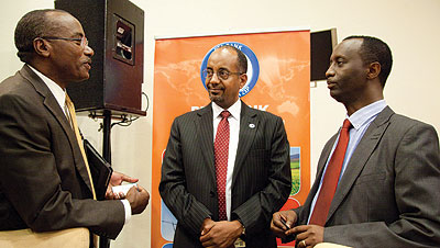 Left-Right; MMM Africa Ltdu2019s Gearge William Rubagumya, Tadesse and Rwanda Development Bank boss Alex Kanyankole discuss after the seminar. The New Times / Timothy / Kisambira.