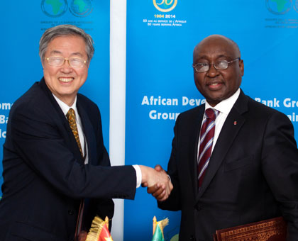 Dr. Zhou Xiaochuan (L), Governor People's Bank of China, shakes hands with AfDB President Dr. Donald Kaberuka after the signing ceremony. (Timothy Kisambira)