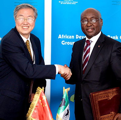 Dr Zhou Xiaochuan (L) governor Peoples Bank of China shakes hands with AFBD president Dr Donald Kaberuka after the signing ceremony where China committed $2bn towards an AfDB fund. T. Kisambira 