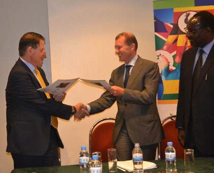  TradeMark East Africa chief executive officer Frank Matsaert u200b (L), exchanges papers with Marc Pecsteen, Belgian ambassador to Rwanda (C), after the signing as Minister for Trade and Industry, Francois Kanimba,u200b(R) looks on. Courtesy u200b