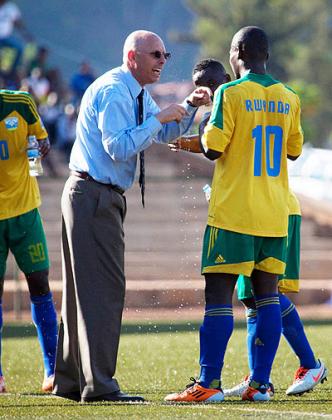 Stephen Constantine speaks to striker Michel Ndahinduka (#10) and defender Solomon Nirisarike during Saturdayu2019s CAN 2015 qualifier. Timothy Kisambira.