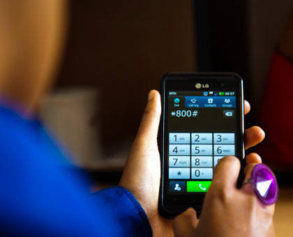 A user searching a mobile phone. Online registration and voting would make it easier for Rwandans who live overseas to participate in the electoral process. File. 