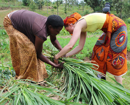 Artisan Dusabirane (L) works with Azizi Life to share everyday life in Rwanda with tourists such as Canadian Emma Bider (R). Kierra Jones.