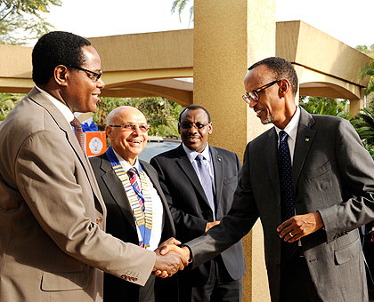 President Kagame is welcomed to the Africa Insurance Organisation meeting by Jean Baptiste Ntukamazina (L), the chairperson of Insurers Association of Rwanda, AOI president Abd el Raouf Ratb and Finance Minister Claver Gatete in Kigali yesterday. (Village Urugwiro)