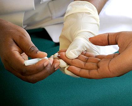 A volunteer testing for HIV at King Faisal Hospital. (Timothy Kisambira)