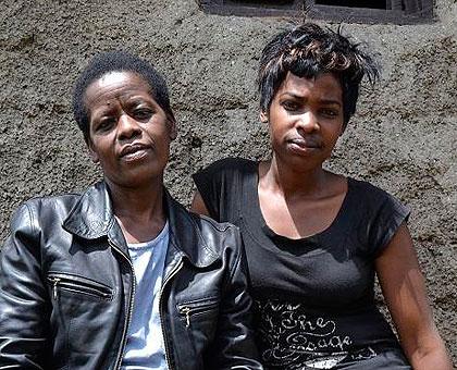 Kabaradine (L) with Merci Irakoze at their home. (Jean d'Amour Mbonyinshuti)