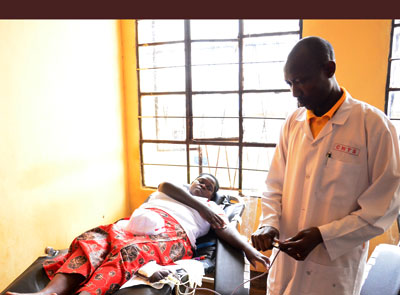 A woman donates blood during the World Blood Donor Day celebration in Gisagara. Sarah Kwihangana. 