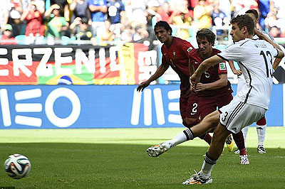 Spot on: Muller dispatches the penalty into the corner with ease to set Germany on their way 