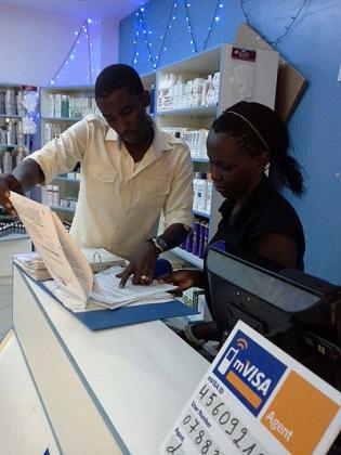 Kayonga checks the storeu2019s inventories. The young business man overcame hard times to make a mark in cosmetics dealership. The New Times / Peterson Tumwebaze.