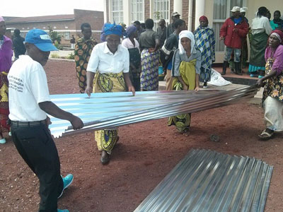 Some of beneficiaries collect their iron sheets yesterday. (Jean du2019Amour Mbonyinshuti)