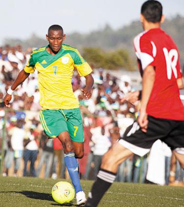 Jean Baptiste Mugiraneza, left, seen here in action against Libya last month. The midfielder believes Amavubi is taking the right direction. T. Kisambira. 