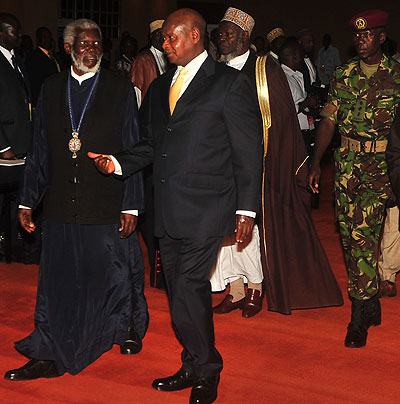 Ugandan President Yoweri Kaguta Museveni talks to his eminence metropolitan Jonah Lwanga after the opening of the African faith leadersu2019 summit on Post-2015 MDGs agenda in Kampala, Uganda yesterday. Courtesy.