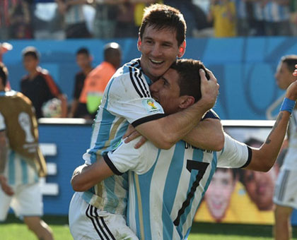 Argentina's forward and captain Lionel Messi (left) and Argentina's midfielder Angel Di Maria celebrate after scoring their only goal in their 1-0 win over Switzerland. (Internet photo)