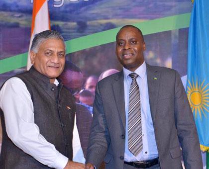 Vijay Kumar Singh, the Indian Minister of State for External Affairs, (R) shake hands with Rwandau2019s envoy to India, Ernest Rwamucyo, during the 20th Liberation celebration. (Courtesy)