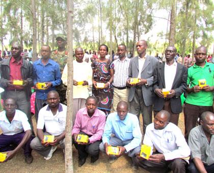 Some of the local leaders pose for a photo with the new phones. (Stephen Rwembeho)