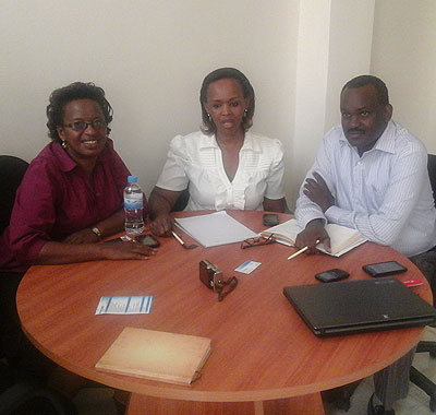 The right attitude will take you places. Bora (C) and her workmates at their office in Remera. P. Tumwebaze.