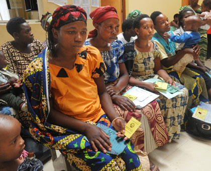 Patients with Mutuelle de Sante insurance cards at Gashora Health Centre await healthcare. File.