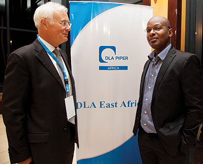 Church (left) chats with Moses Gatama Kiiza of Equity Juris Chambers during the retreat at the Serena Kigali Hotel. The global law firm has expanded its operations in East Africa. The New Times / Timothy Kisambira